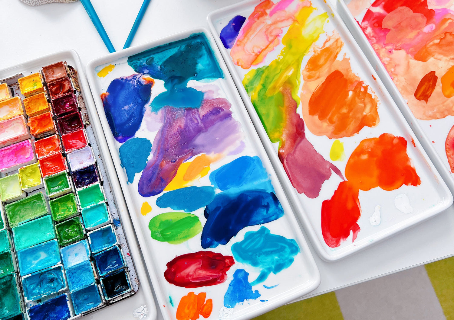 A cozy peek into Sun Lee’s art studio – a bright, creative space filled with colorful paints, brushes, and art supplies. Her desk is neatly arranged with works-in-progress, sketchbooks, and favorite tools, offering a glimpse into her artistic process and daily workspace.