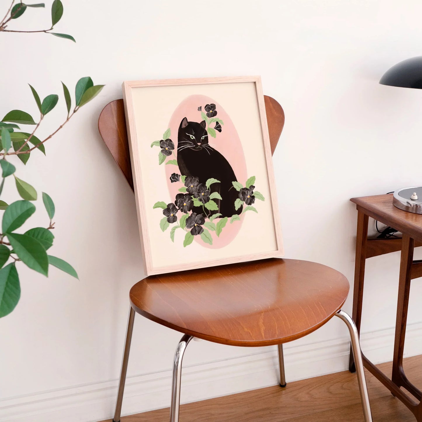 Vertical portrait illustration of a black cat surrounded by black pansy flowers, with a soft and feminine mood