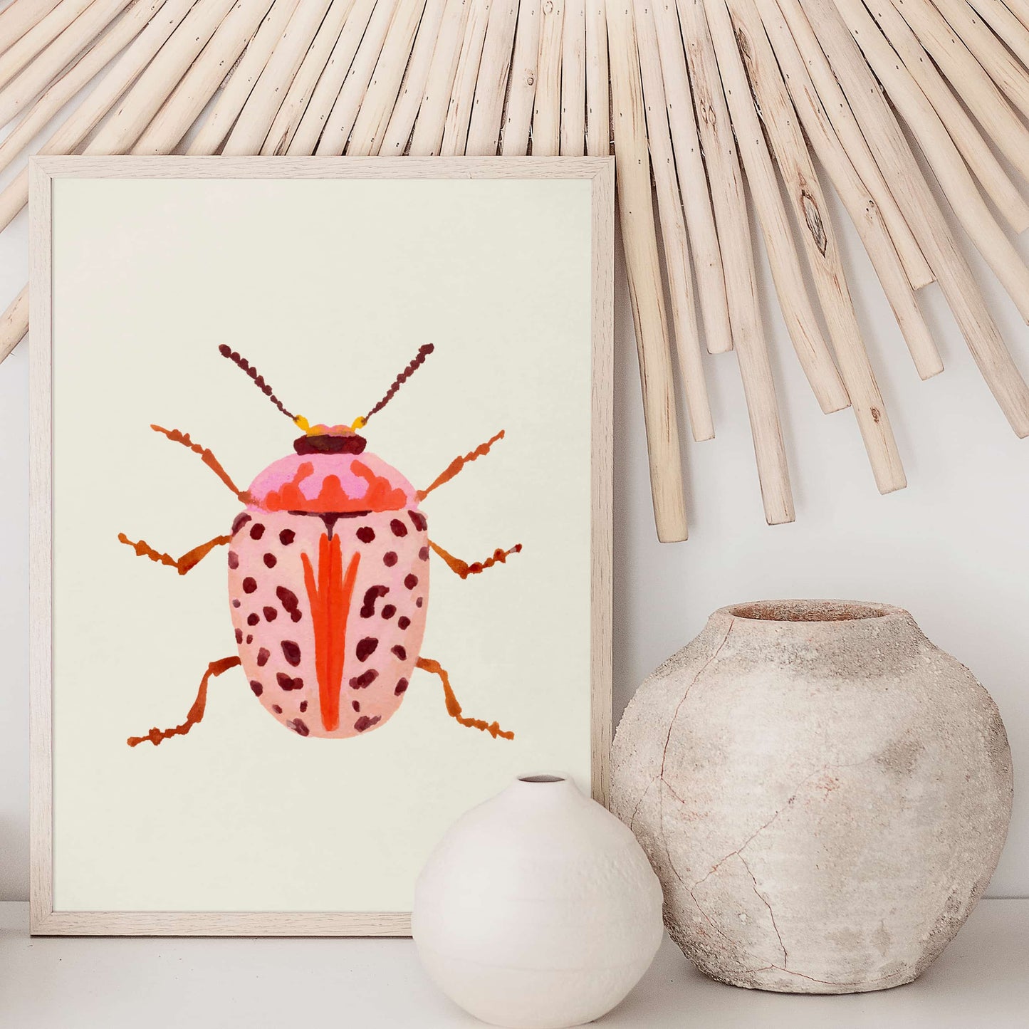 Gouache painting of a blush-colored beetle with coral and baby pink tones, accented with wine-maroon dots and curving tentacle-like antennae. A soft yet striking insect illustration.