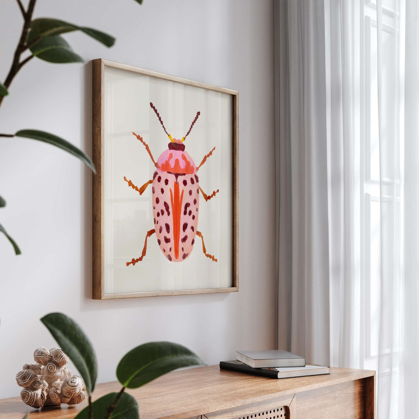 Gouache painting of a blush-colored beetle with coral and baby pink tones, accented with wine-maroon dots and curving tentacle-like antennae. A soft yet striking insect illustration.