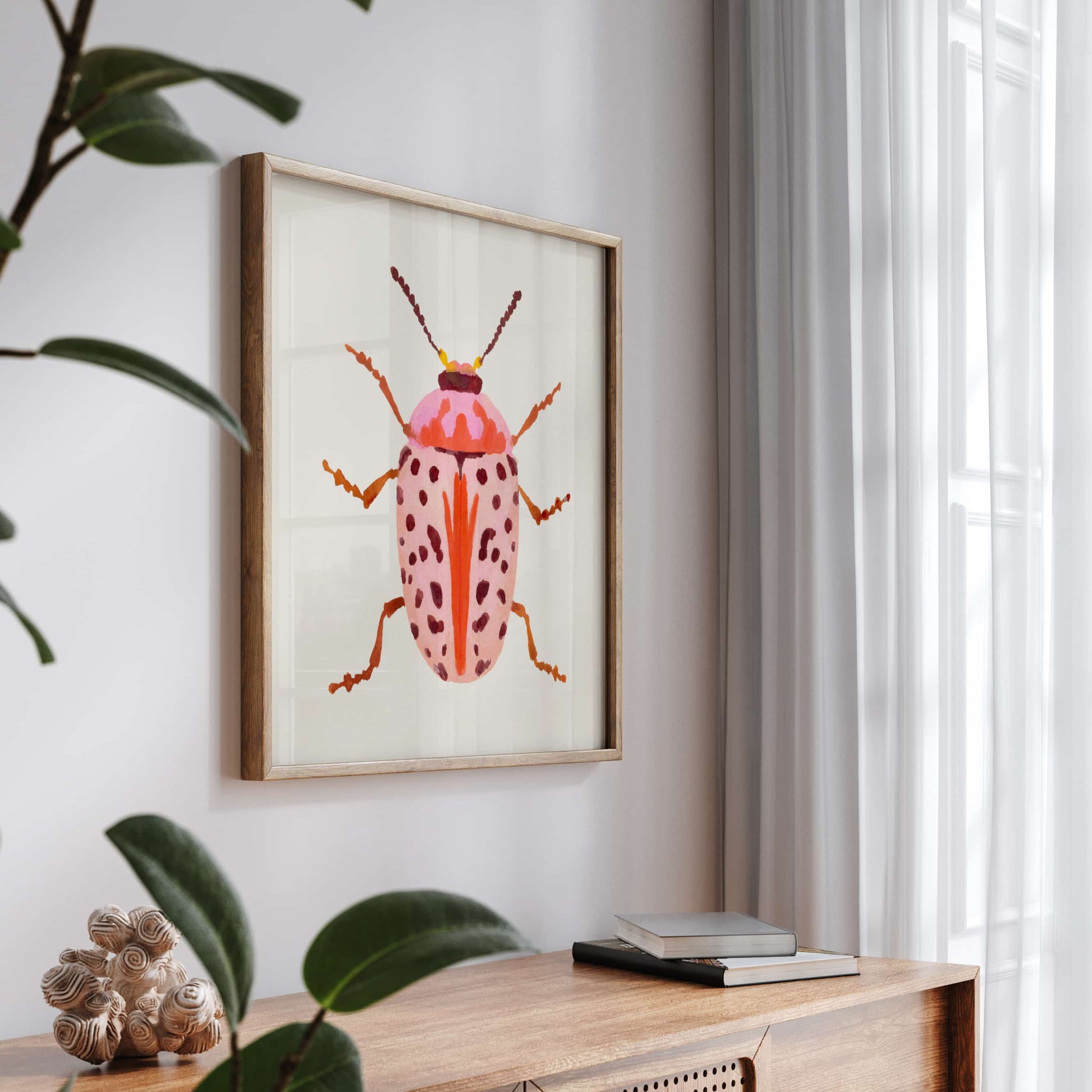 Gouache painting of a blush-colored beetle with coral and baby pink tones, accented with wine-maroon dots and curving tentacle-like antennae. A soft yet striking insect illustration.