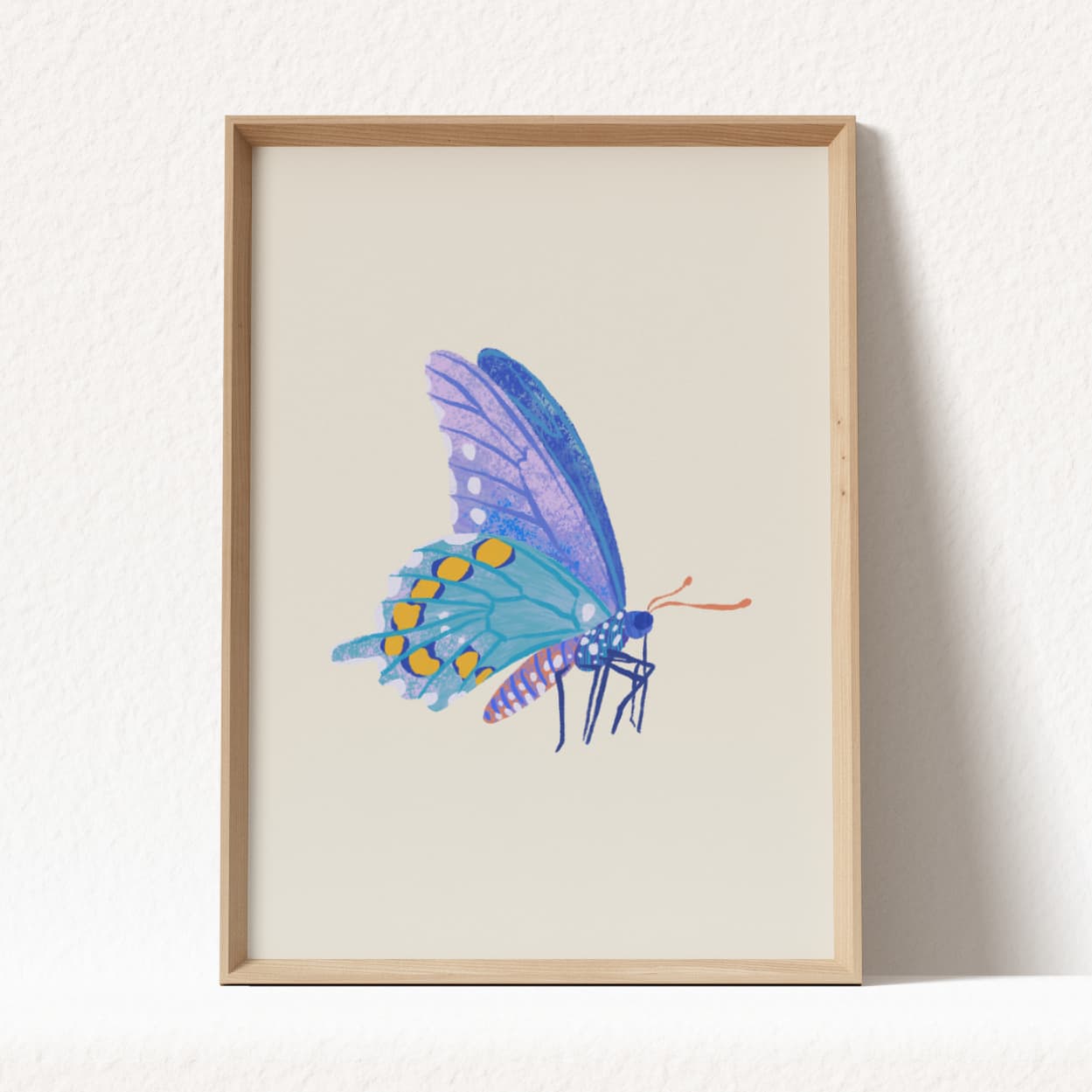 Framed artwork of a blue butterfly on a beige background