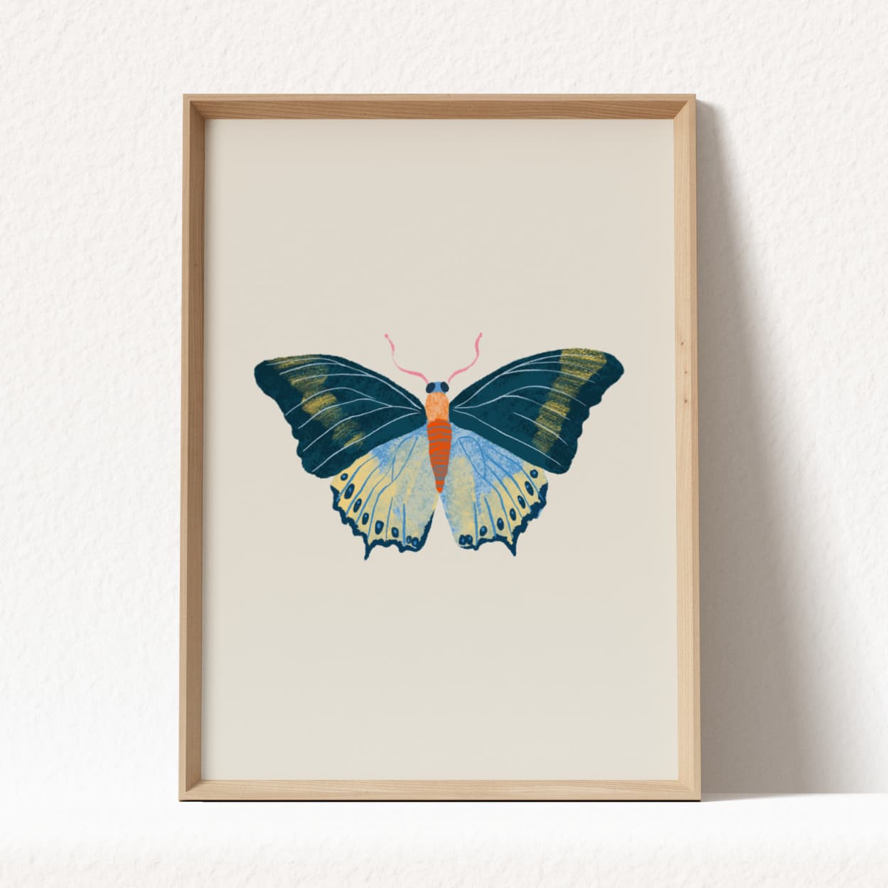 Framed artwork of a butterfly on a white background