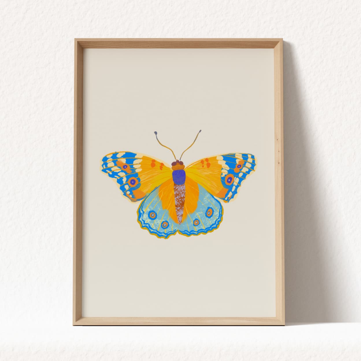 Framed artwork of a colorful butterfly on a white background