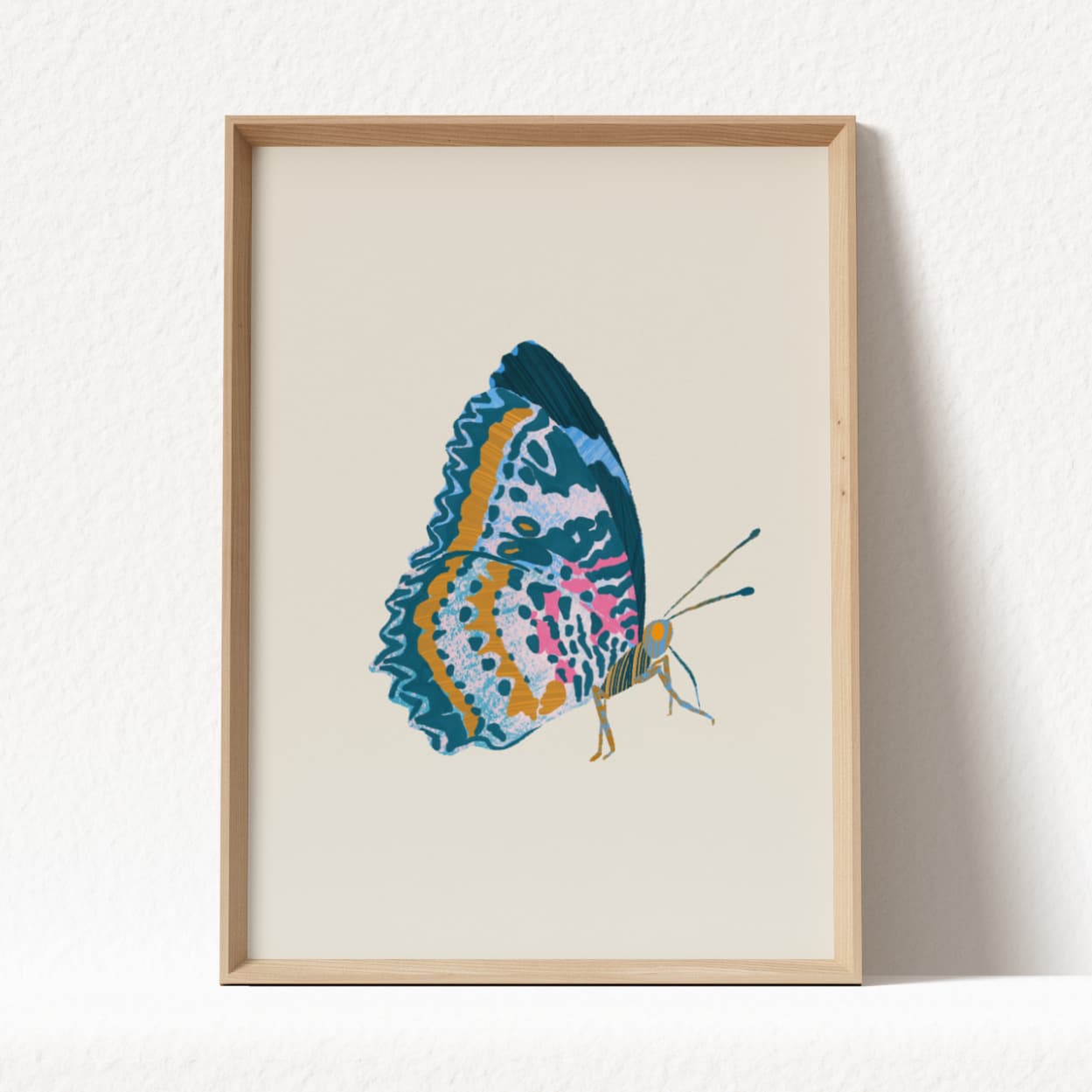Framed artwork of a colorful butterfly on a beige background