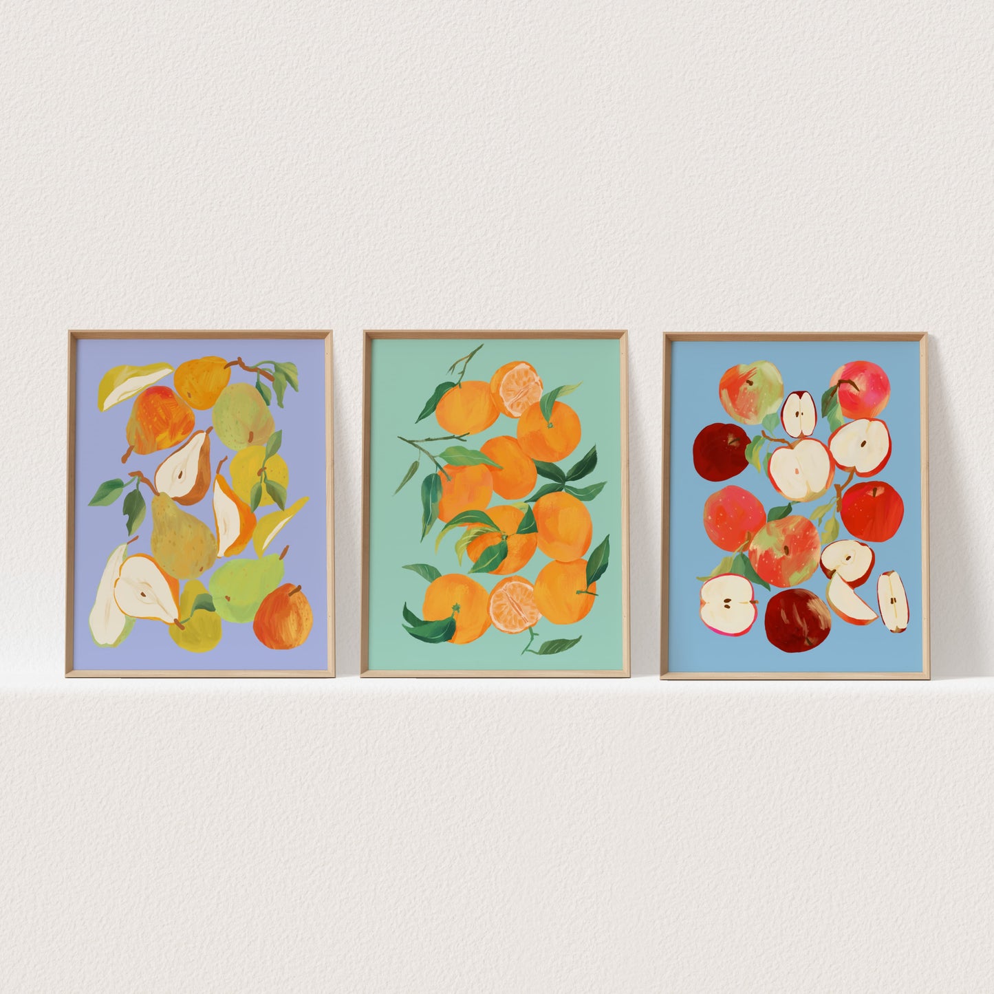 Set of three still life art prints featuring tangerines, apples, and pears in colorful arrangements.
