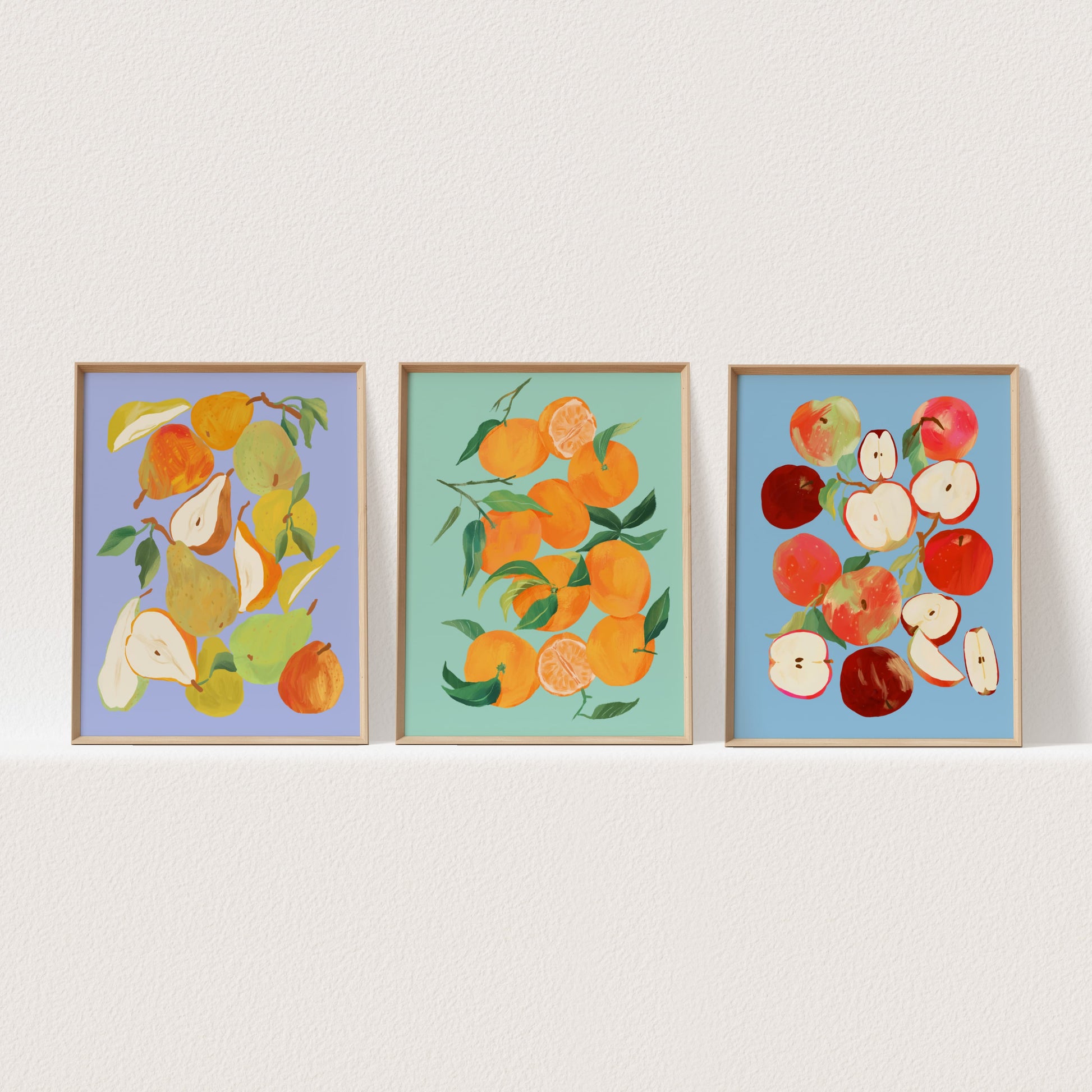 Set of three still life art prints featuring tangerines, apples, and pears in colorful arrangements.
