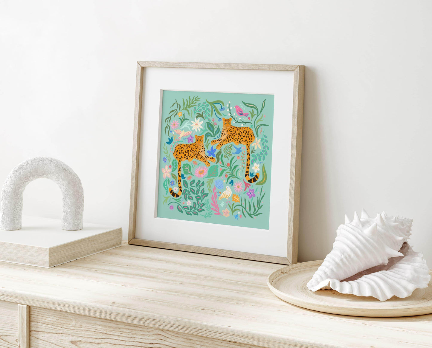 Playful illustration of cheetahs surrounded by colorful flowers, birds, and nature elements – vibrant and fun animal art print for nature-inspired home decor