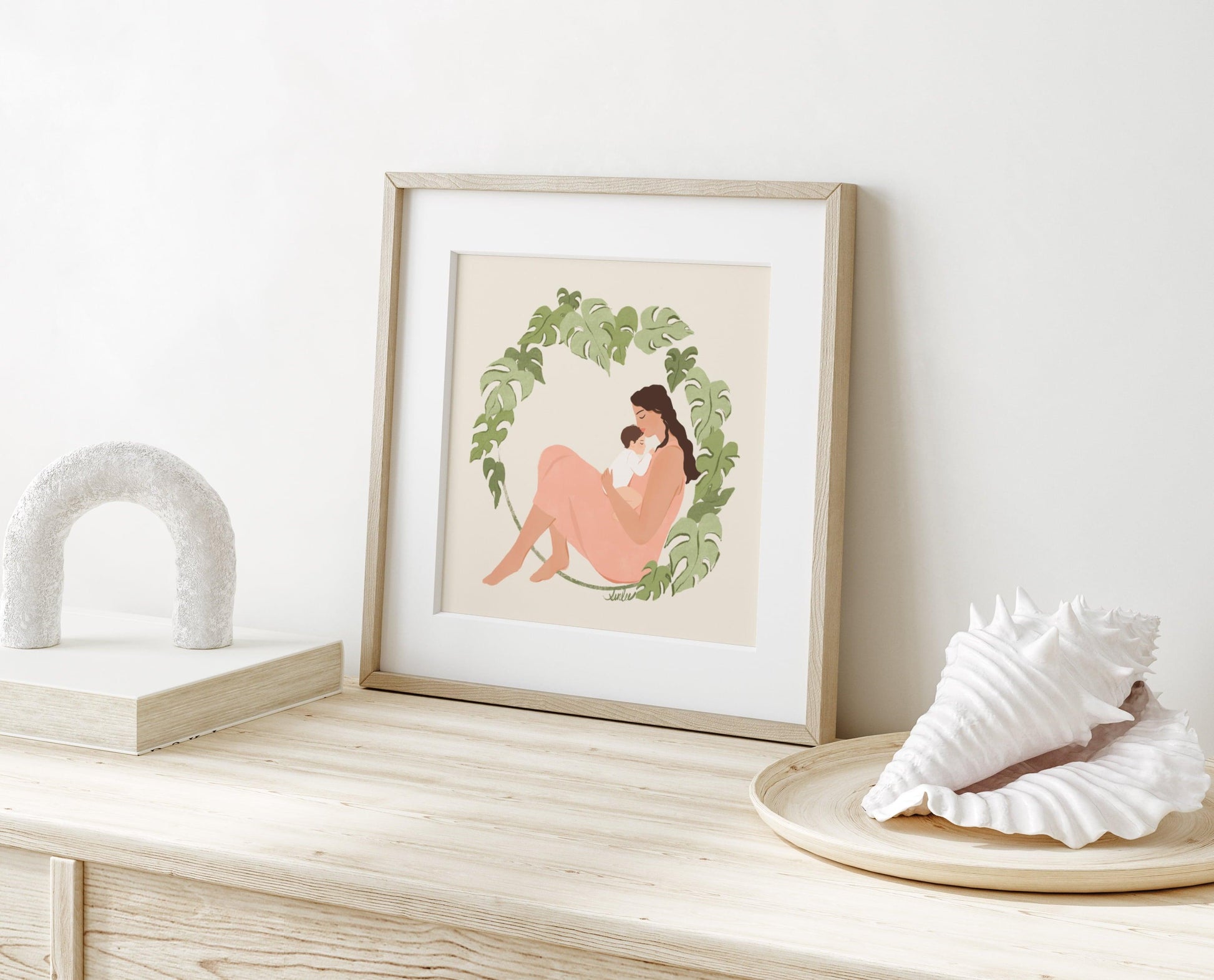 Tender art print of a mother and baby surrounded by lush monstera foliage – serene illustration with soft textures celebrating nurturing and natural beauty