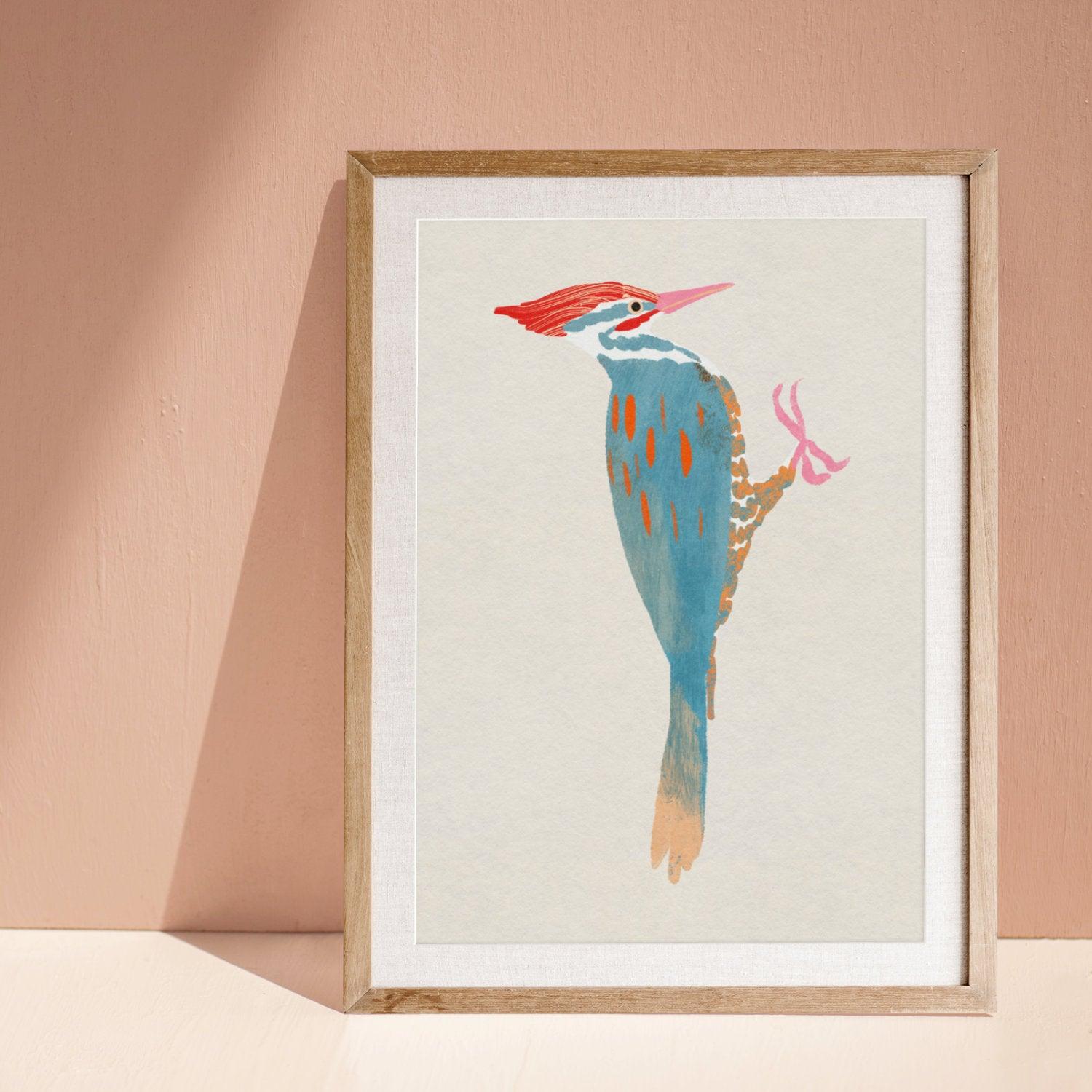 A whimsical art print of a Pileated Woodpecker, illustrated in vibrant colors and playful details. The bird is perched in a natural setting, capturing its bold features and lively spirit—an artistic tribute to this striking forest visitor.