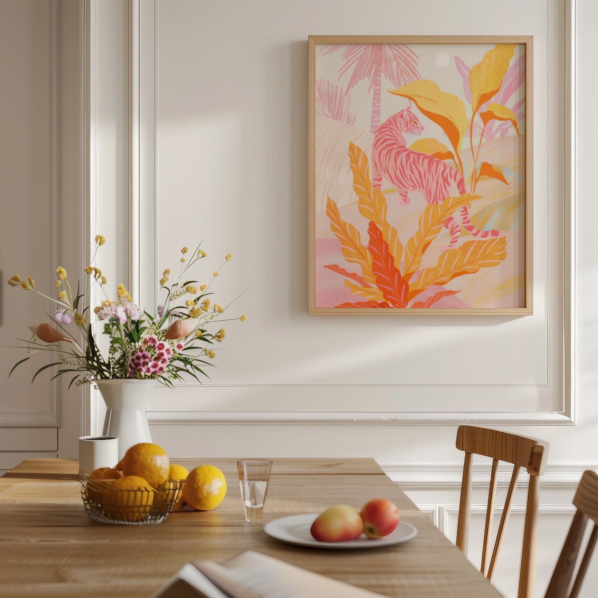 Dining room with a table set with fruit and flowers, a vase, and a colorful abstract painting on the wall.