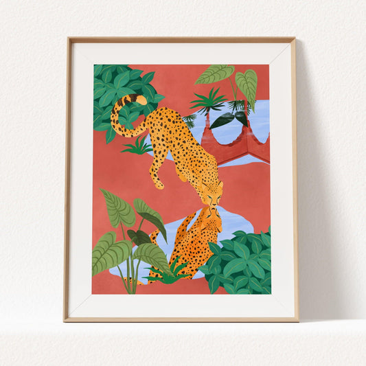 Giclee art print of a cheetah drinking water from a serene pond, with a beautiful reflection – earthy mud tones and vibrant greens in tranquil nature art print for modern home decor