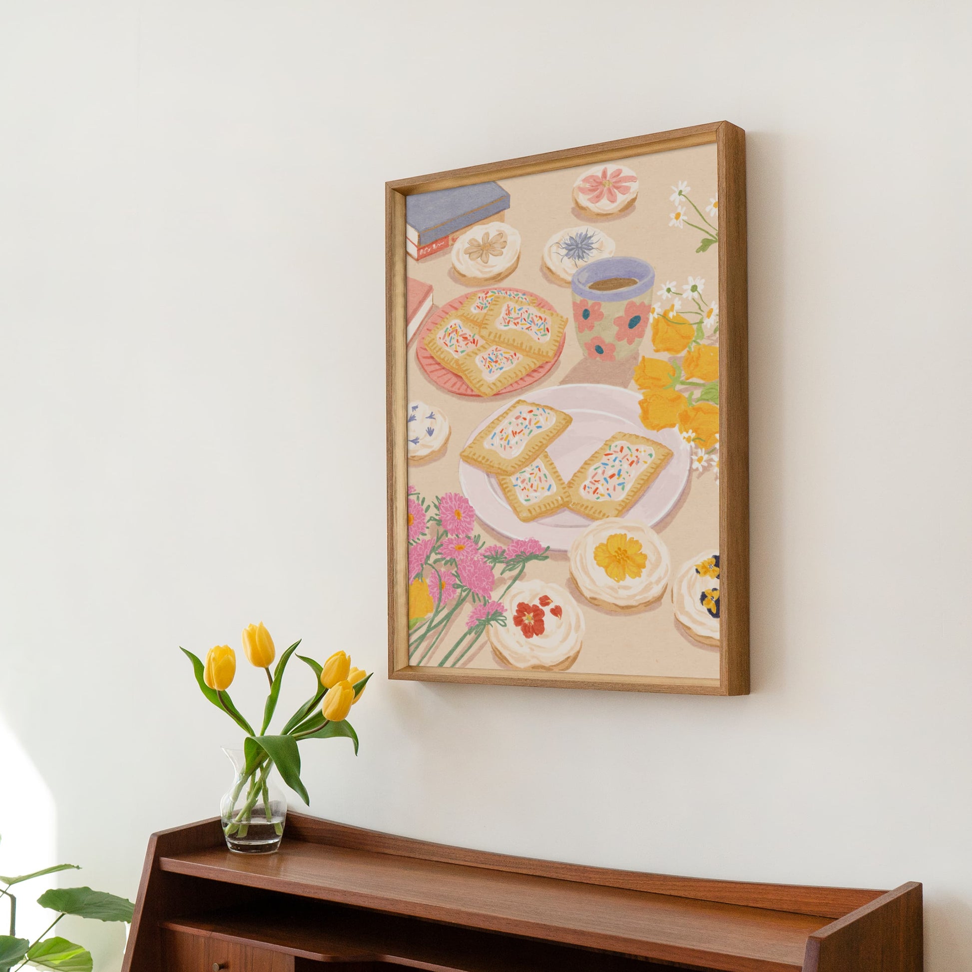 Soft illustration of a cozy table scene with books, flowers, cookies, and desserts topped with edible flowers – titled "Sweet Stillness"