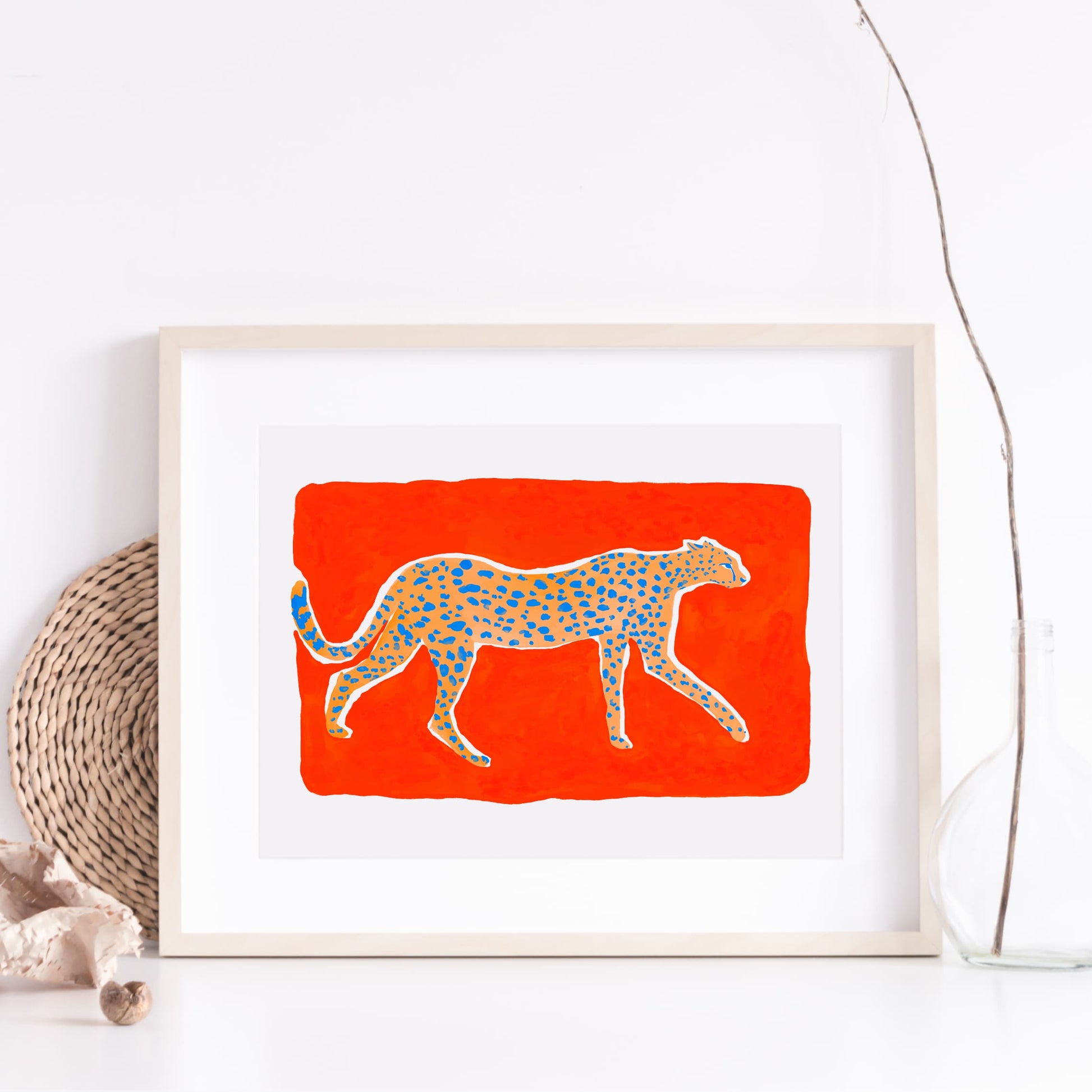 High quality giclée print of a gouache painting by watercolor artist Sun Lee. Features a cheetah walking in profile on a vermilion background. Aesthetic watercolor artwork combining elegance and bold simplicity.