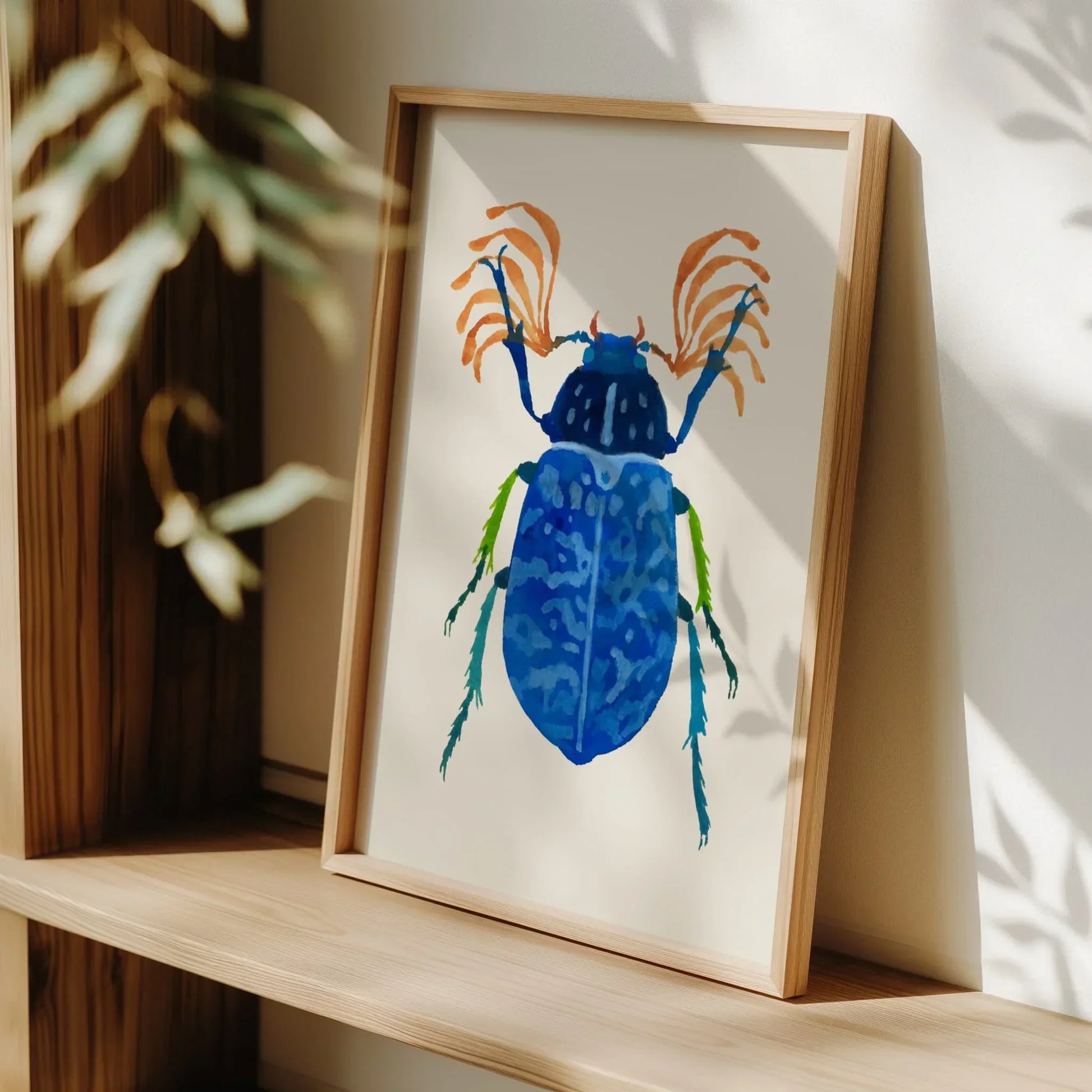 Art print of a vibrant blue beetle with detailed wings and iridescent tones, painted in gouache on textured paper. The beetle is centered against a clean background, highlighting its intricate patterns and vivid color.