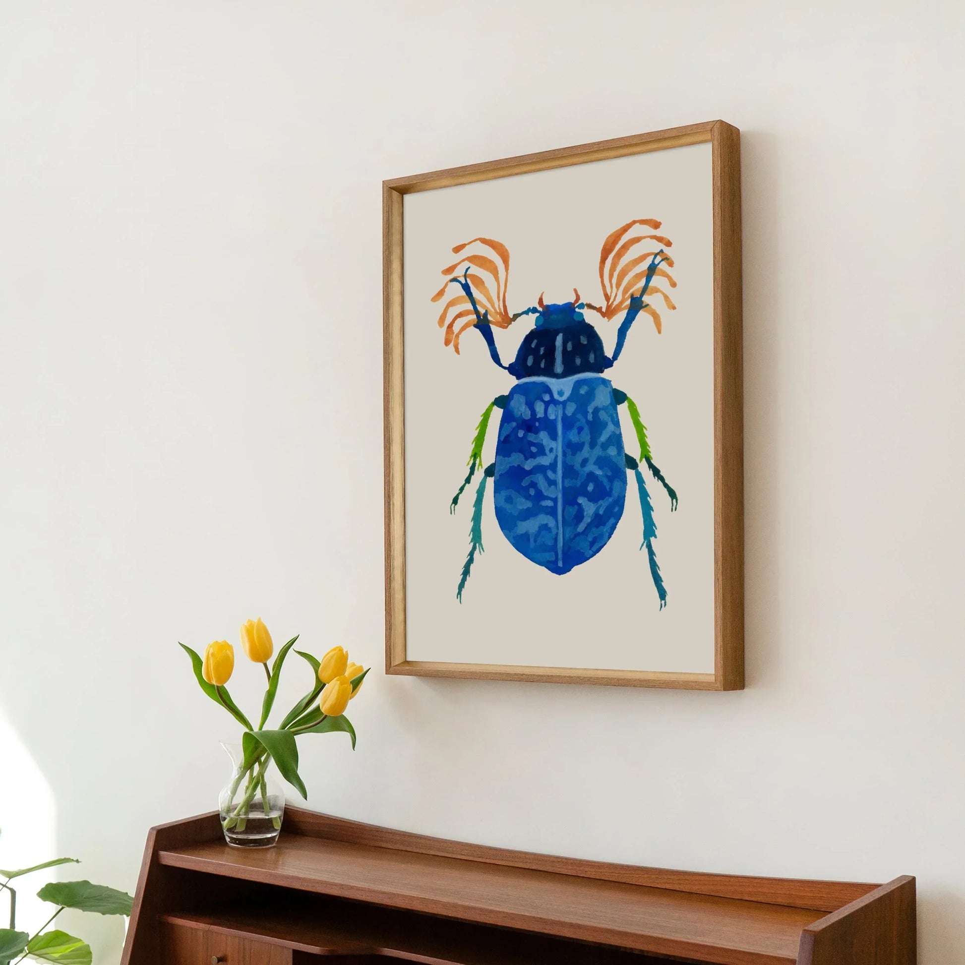 Gouache painting of a vibrant blue beetle with intricate wing details and iridescent hues, centered on a light background. The artwork highlights the beetle’s delicate textures and bold color.