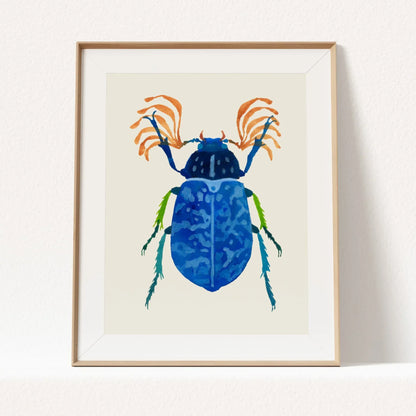 Art print of a vibrant blue beetle with detailed wings and iridescent tones, painted in gouache on textured paper. The beetle is centered against a clean background, highlighting its intricate patterns and vivid color.