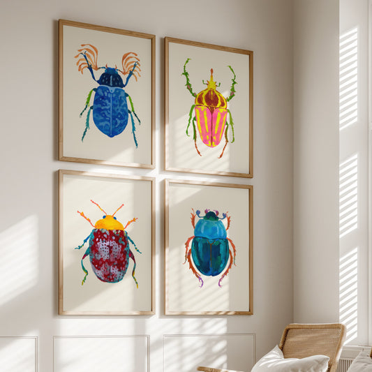 Four colorful beetle illustrations in wooden frames on a wall.