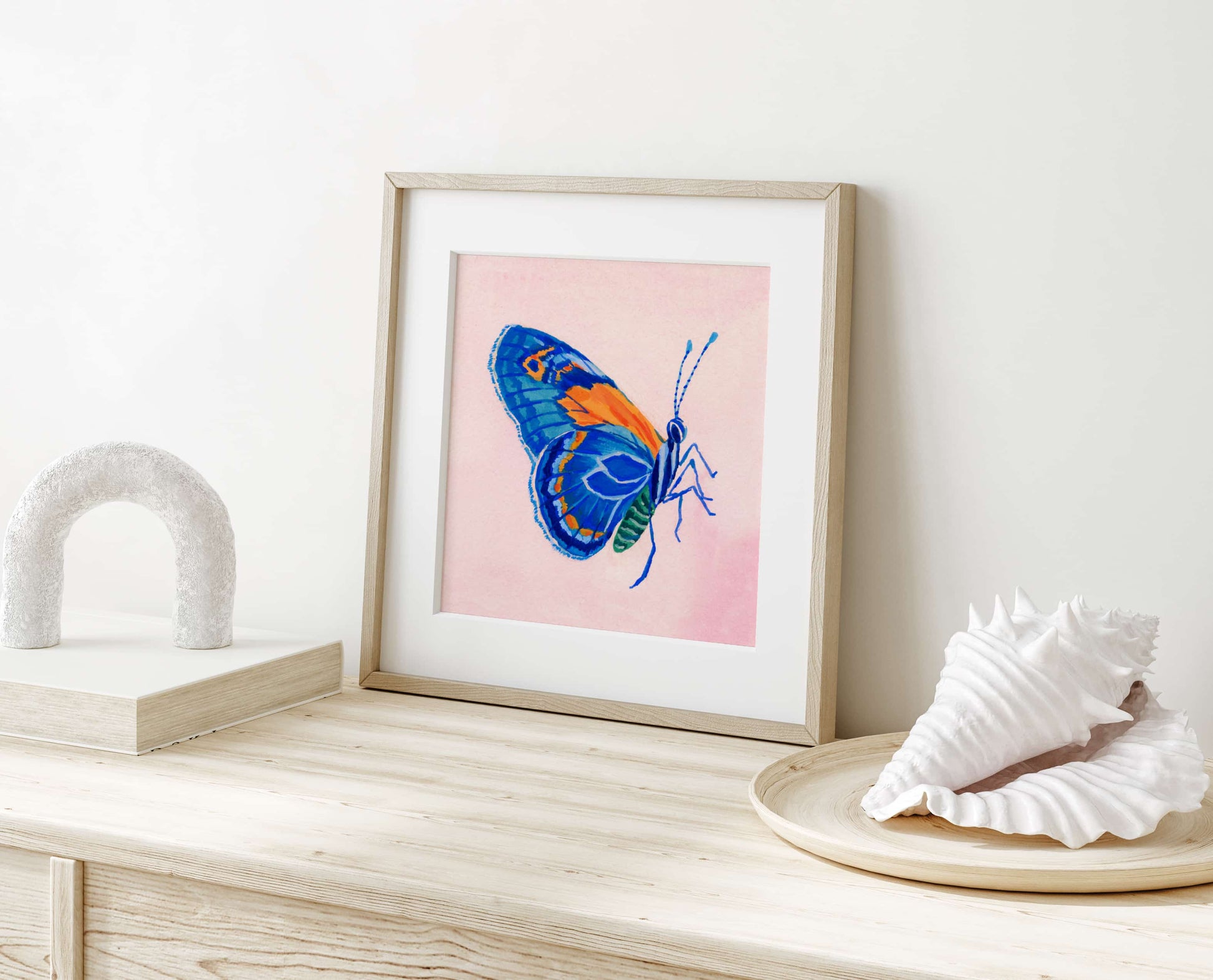 Hand-painted blue butterfly artwork with soft pink backdrop