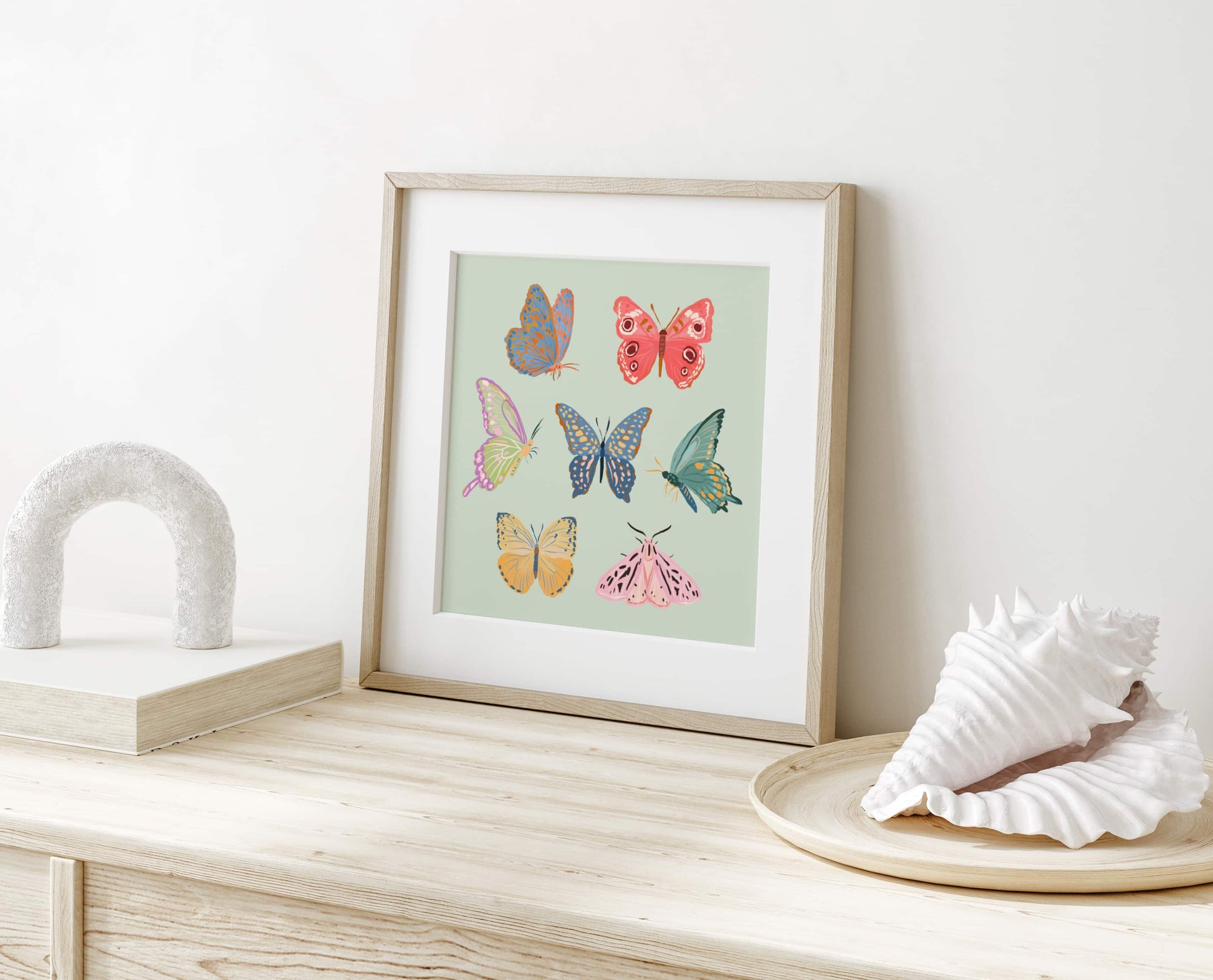 Minimal, whimsical illustration of butterflies and moths in soft pastel tones.