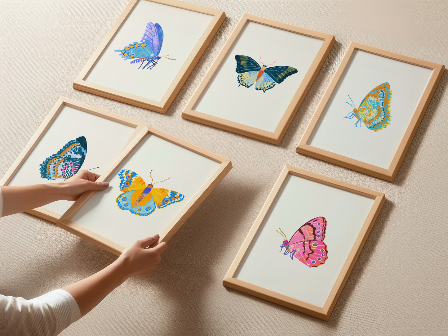 Framed illustrations of butterflies on a beige wall