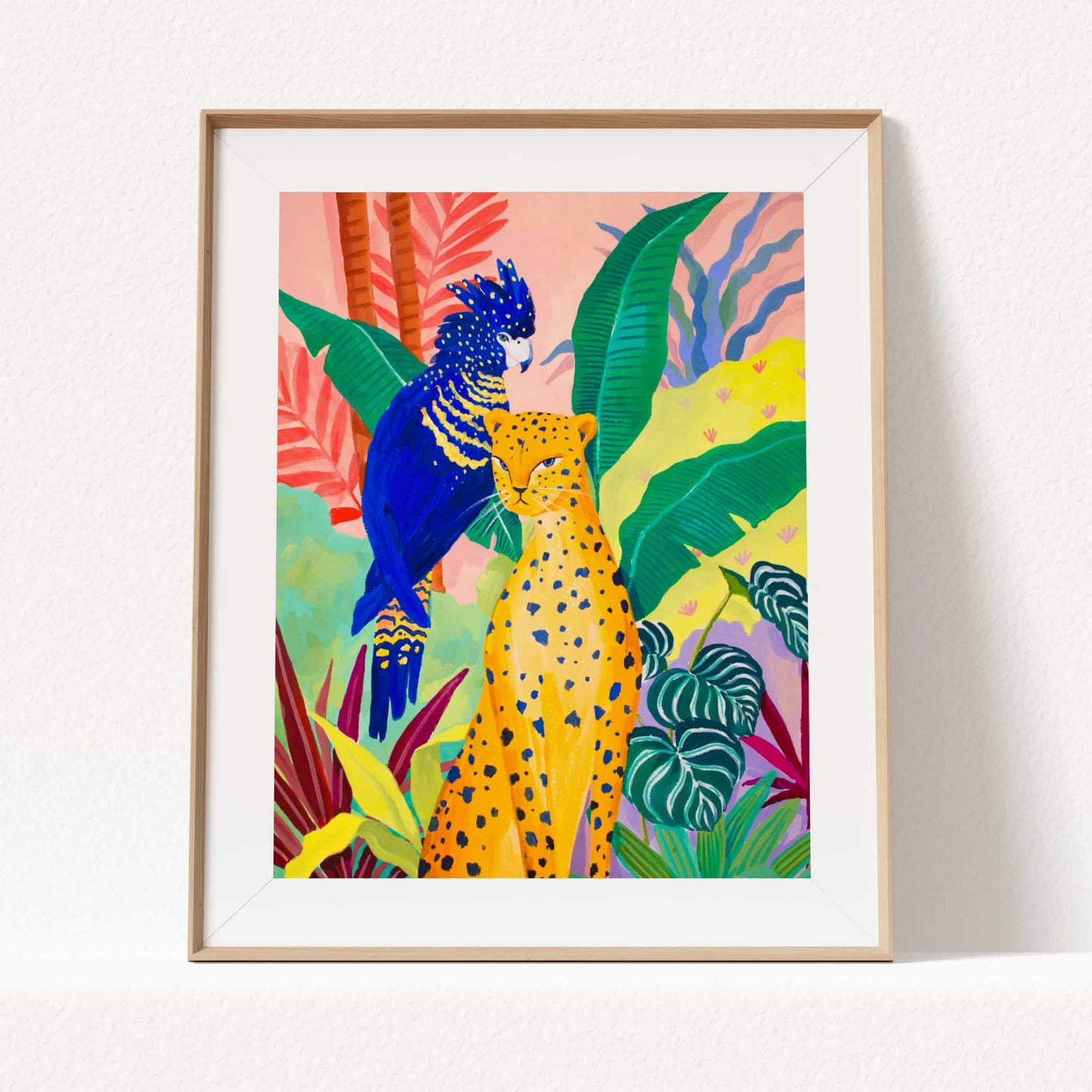 Watercolor and gouache jungle illustration featuring a cheetah, tropical foliage, and a bright blue cockatoo.