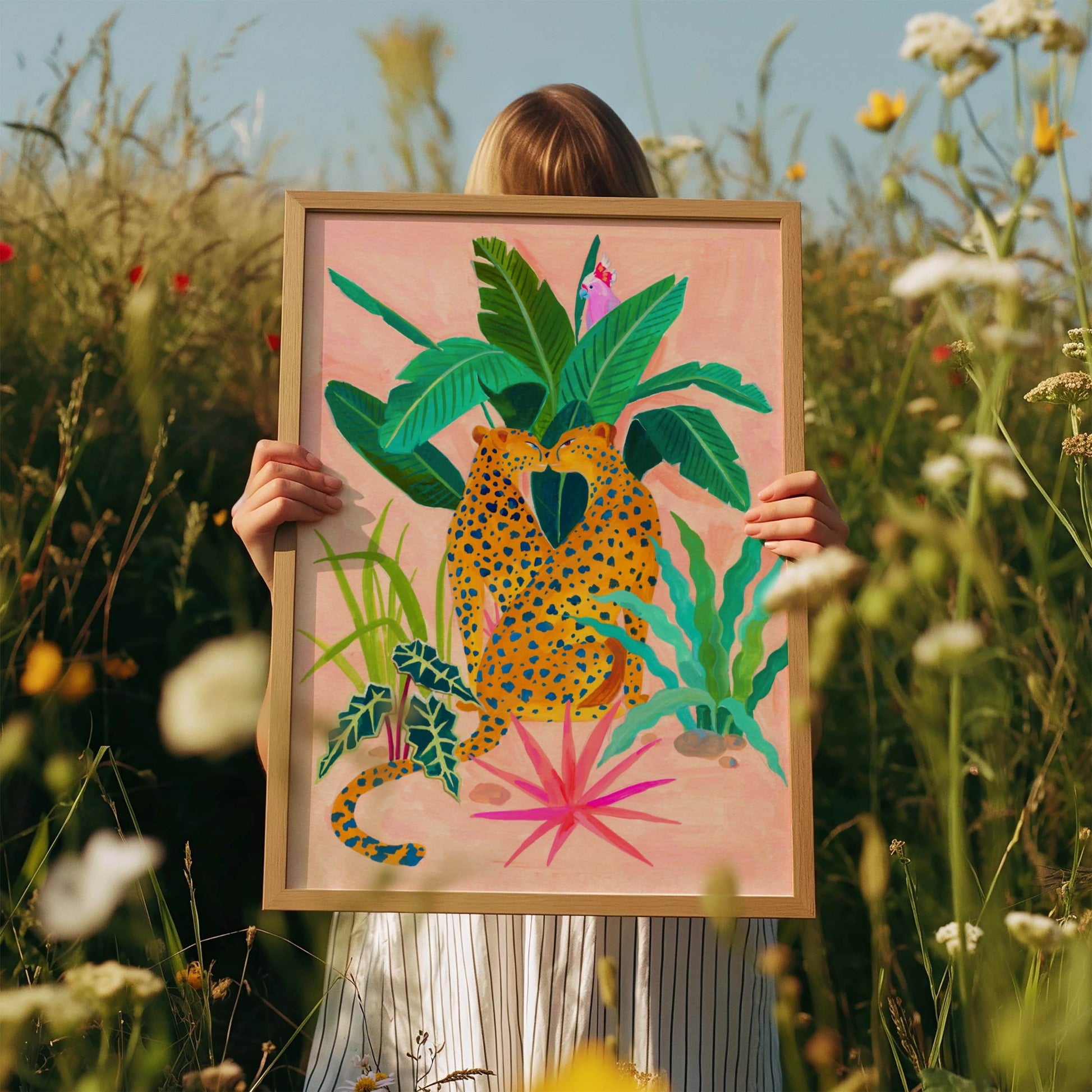 A giclee print features two cheetahs and tropical flora. 