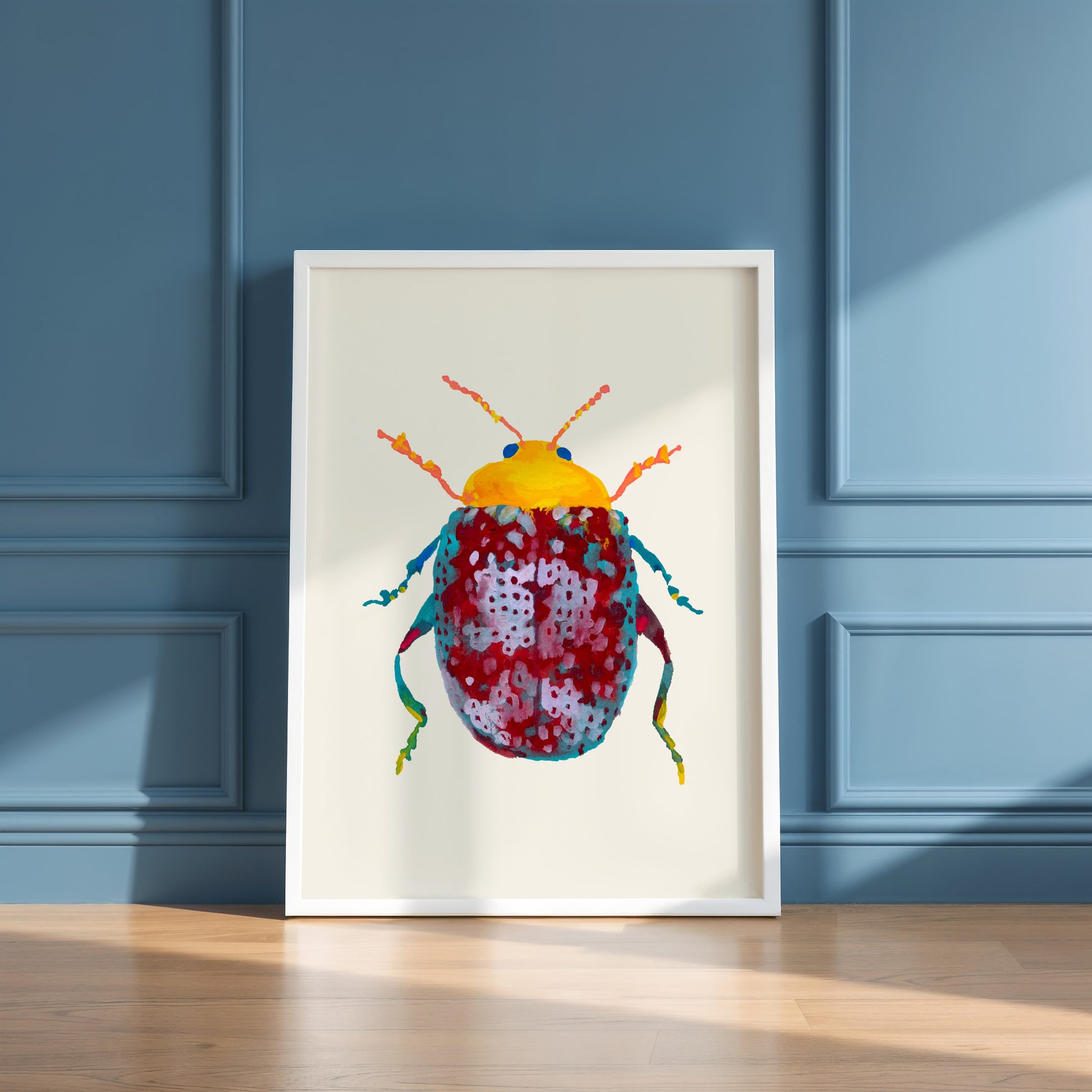 Framed artwork of a colorful beetle on a blue paneled wall.