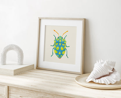 Whimsical insect illustration of a sky blue beetle featuring lime spots and striking yellow-orange antennae, hand-painted with gouache.