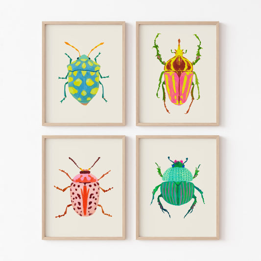 Four framed illustrations of colorful beetles on a white wall.
