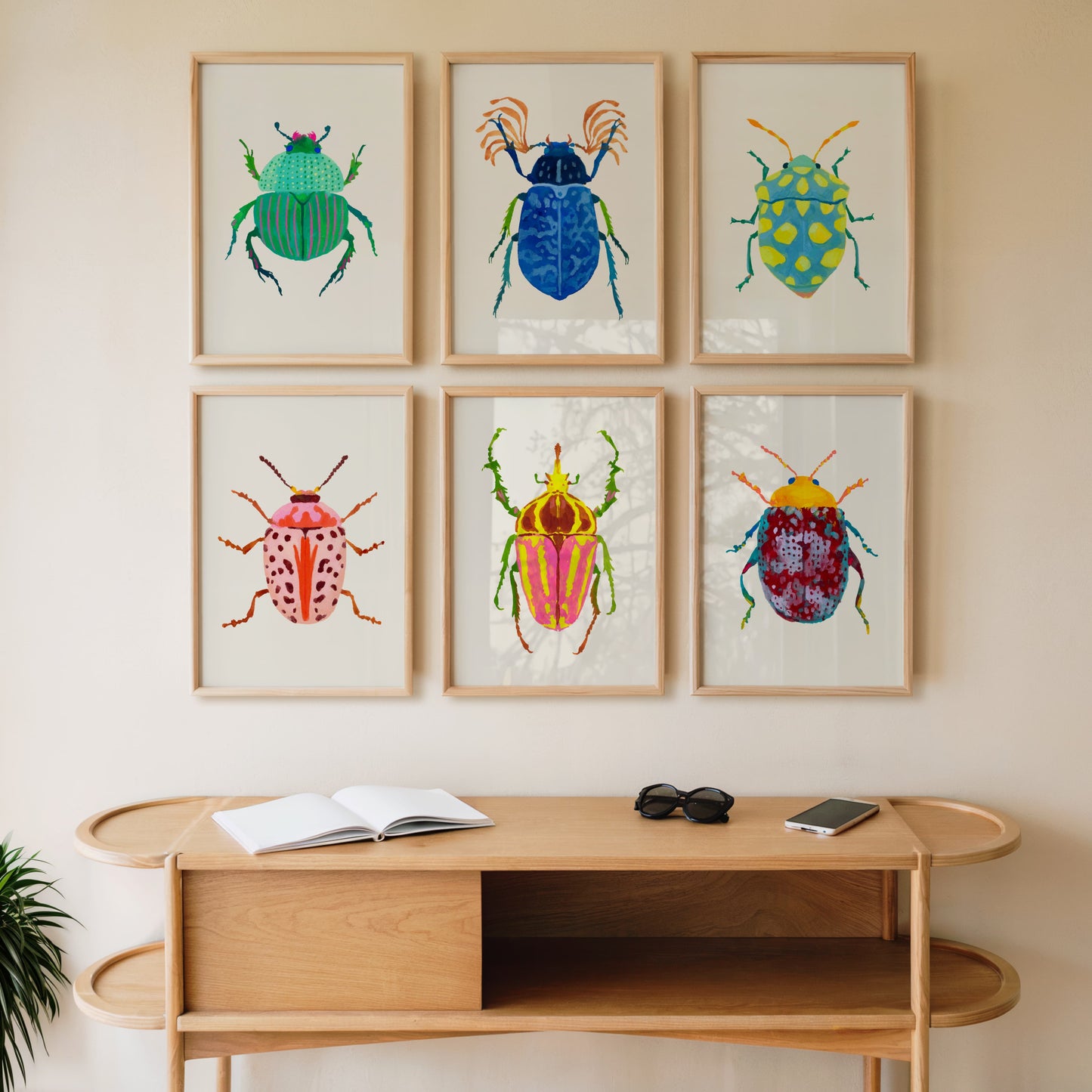 Colorful beetle illustrations on a wall above a wooden console table.